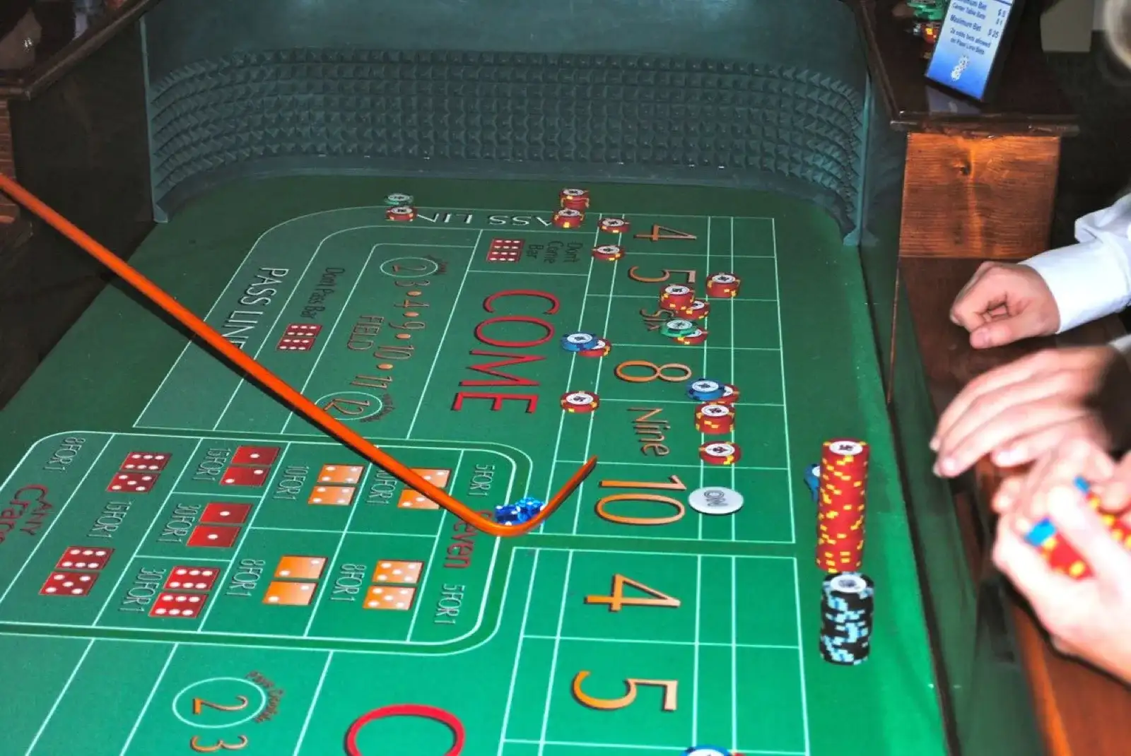 Wide view of a craps table layout showing the pass line, come, and field betting areas