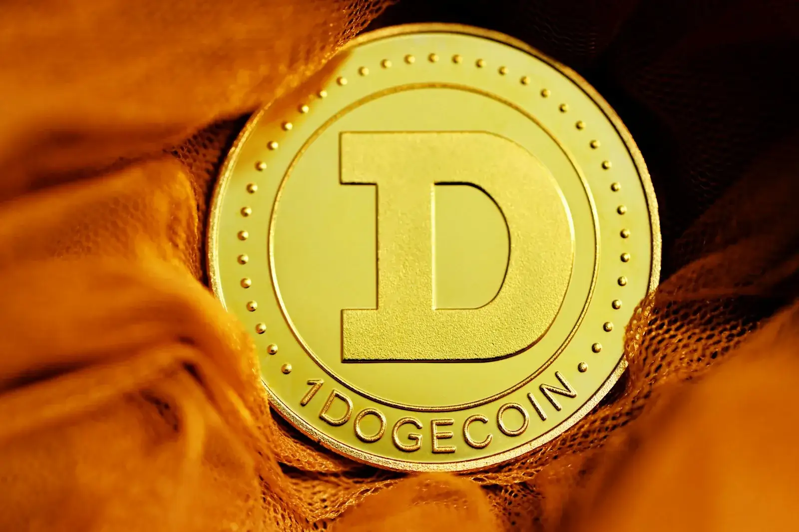 Close-up macro shot of a gold Dogecoin coin